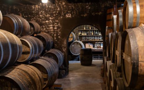 Aging process of cognac spirit in old French oak barrels in cellar in distillery in Cognac white wine region, Charente, Segonzac, Grand Champagne, France